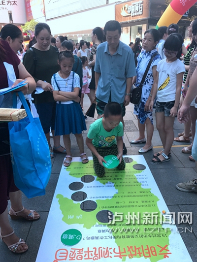 市民在宣傳點(diǎn)參加創(chuàng)文趣味游戲。 記者 朱虹 攝